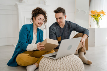 man and woman couple give open gift box presents at home happy smile