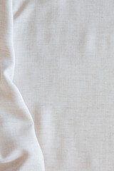 White crumpled linen fabric texture background. Natural off white wavy linen organic eco textiles...
