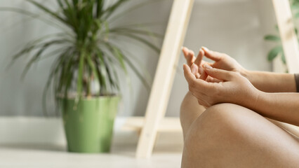 The concept of a healthy lifestyle, yoga and meditation. women's hands close-up, a woman meditating indoors at home