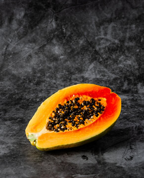 Papaya Half On Black Background.