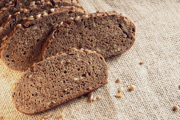 pieces of bread on a cloth with a large cell, healthy whole grain bread with sunflower seeds