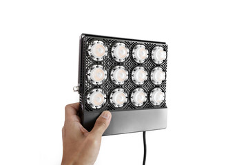 Hand holding brand new LED grow light for indoor plant. Indoor gardening grow light