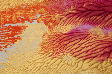 Abstract gold and red color acrylic wave painting stucco wall. Canvas vintage grunge texture horizontal background.