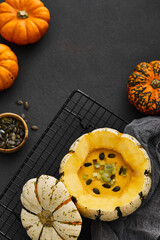 Pumpkin cream soup served in a squash with seeds
