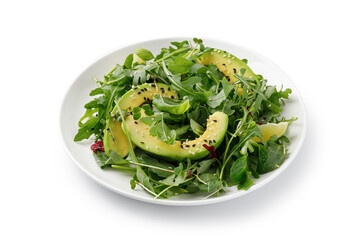 Green vegan salad with avocado and mix lettuce, arugula on white plate isolated on a white background with clipping path, cut out.