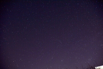 The starry sky on a summer evening. Beautiful stars and night sky. Astrophotography with stars. Noise and bluer from the stars.