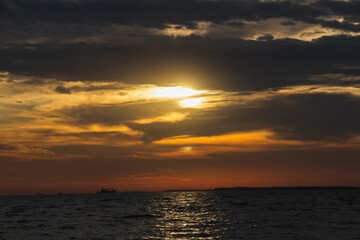 Amazing Black sea sunset, Nature landscape background. Drama sky ,sun and clouds. Blue hour at the ocean romantic evening. Ship on the horizon. Tropical island summer paradise. Night sky meditation
