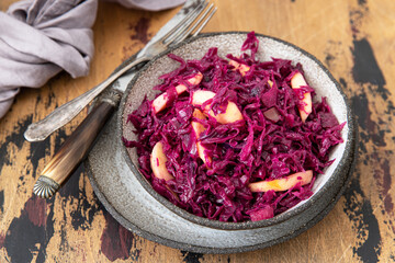 Obraz na płótnie Canvas Red Cabbage salad with apples and pecan nuts. Vegetarian food 