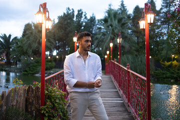 Young, good looking handsome boy on bridge. Amazing landscape.