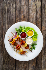 Chicken skewers - grilled meat with vegetables on wooden background
