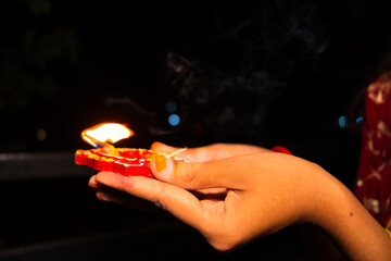 Diwali, Deepavali Hindu Festival of lights celebration. Diya or oil lamp in woman hands with dark...