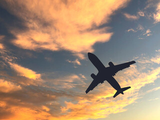Fototapeta na wymiar Silhouette of a passenger cimbing after take off againsts a sunset sky. No people. Copy space.