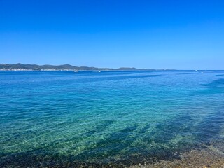 Blue sea horizon, blue sky, natural colors, pure sea water surface