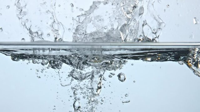 Pear splashed fizzy water closeup. Fresh yellow fruit fall under bubbles liquid