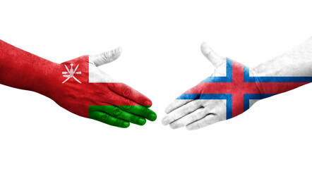 Handshake between Faroe Islands and Oman flags painted on hands, isolated transparent image.