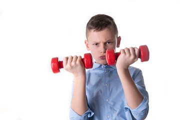 young boy in blue shirt lifts dumbells