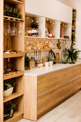 Kitchen interior decorated with Christmas garlands and Christmas trees