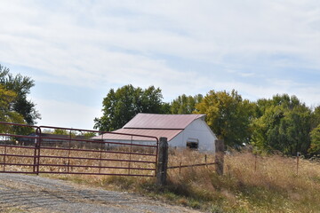 Barn by a Fence in a Farm Field