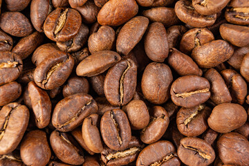 Coffee beans detailed on the background, aromatic coffee beans, place for inscription.