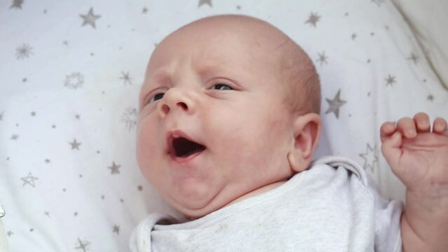 1080p slow motion footage video. Close up newborn baby child lying in baby carriage stroller buggy having fun playing, looking at her mother, smiling infant. Outside walking in pushchair, fresh air

