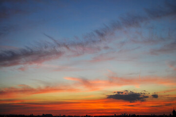 beautiful sunset sky over the night town horizon