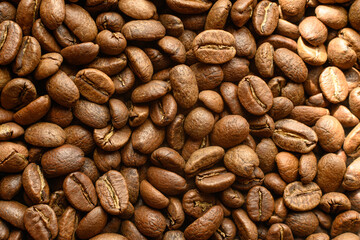 Black coffee beans with a slight haze from the steam, the texture of coffee beans.