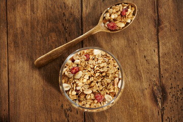 granola with dried fruits in a jar on a wooden table