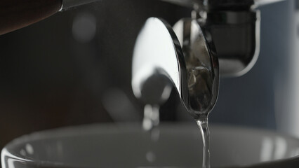 rinsing coffee machine with double spout portafilter closeup