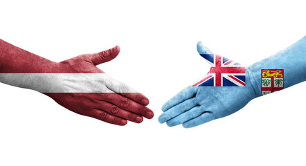 Handshake between Fiji and Latvia flags painted on hands, isolated transparent image.