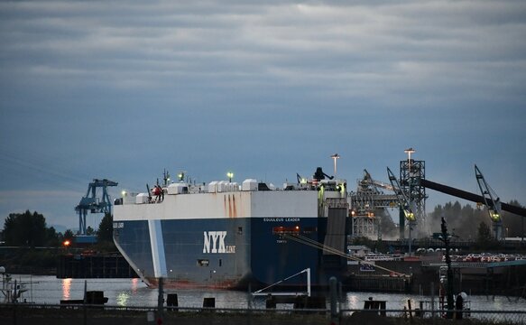 NYK Line cargo ship, offloads new cars from Tokyo Japan.