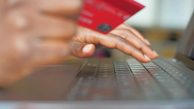 Young woman using her laptop shopping online with a debit or credit card. Using online banking. 