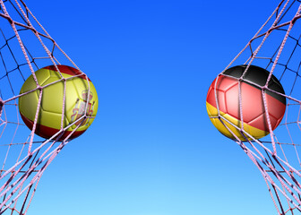 Two soccer balls in flags  Spain and Germany