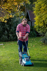 Man mowing lawn at home