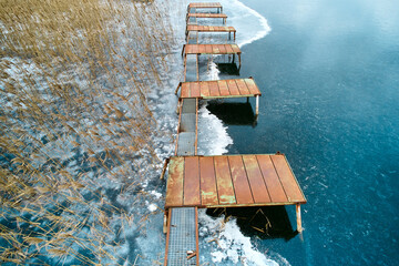 Rusty metal pier on frozen lake. Aerial view of pier on frozen lake