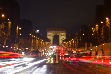 The Triumphal Arch and Champs-Elysees avenue in rainy evening, Paris, France.