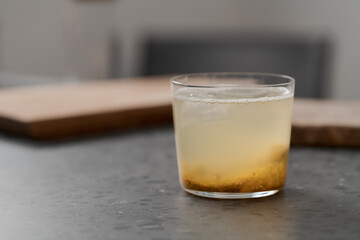 organic drink with lulo fruit in tumbler glass on concrete background with copy space