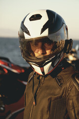 Portrait of a motorcycle rider with helmet.