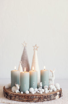Handmade modern advent wreath with four candles lit every sunday before christmas. Traditional diy xristmas decoration