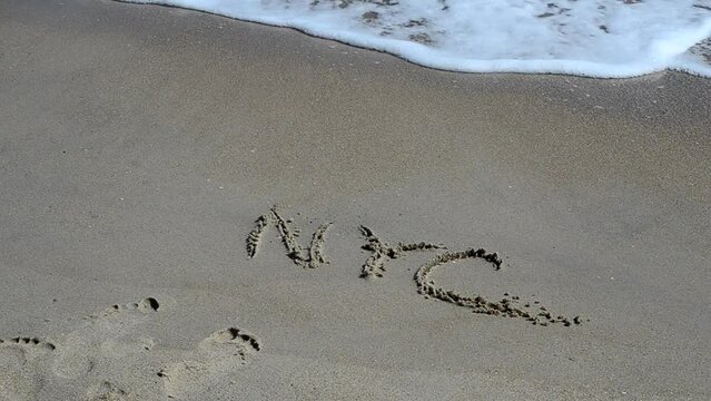 NYC Written in Sand at Beach. New York an inscription