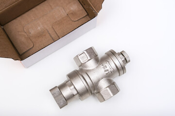 Water flow regulator, pressure reducer valve on white background, new repair part for plumbing, water supply in a house