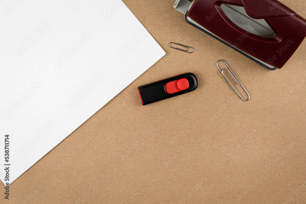 Aufkleber work place top view with office supplies on textured recycled craft brown paper backdrop copy space