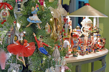 A Christmas tree decorated with nutcracker ornaments and a table display of various nutcrackers.