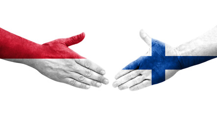 Handshake between Finland and Monaco flags painted on hands, isolated transparent image.
