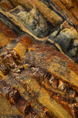 Natural rock texture of a colorful rock formations in silence beach (playa del Silencio) in Asturias, north of Spain.