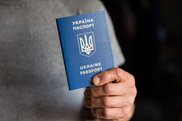 Man holding Ukrainian passport in his hands