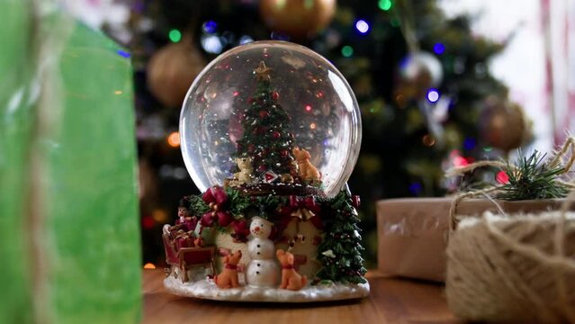 Christmas snowglobe with Christmas tree and snow falling inside 