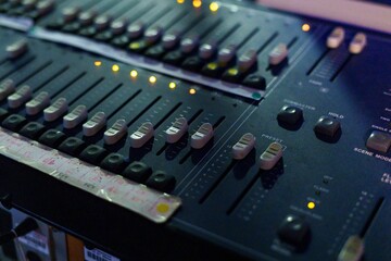 Close-up shot of an audio mixing desk controls