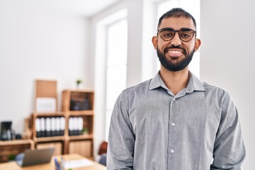 Young hispanic man business worker smiling confident at office