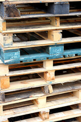 Pile of wood pallet skids closeup vertical 