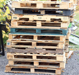 Tall pile of wood pallet skids